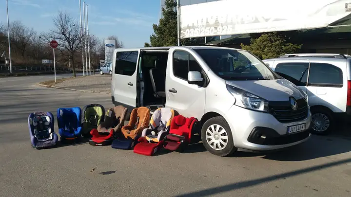 Child seats and boosters ready next to a van