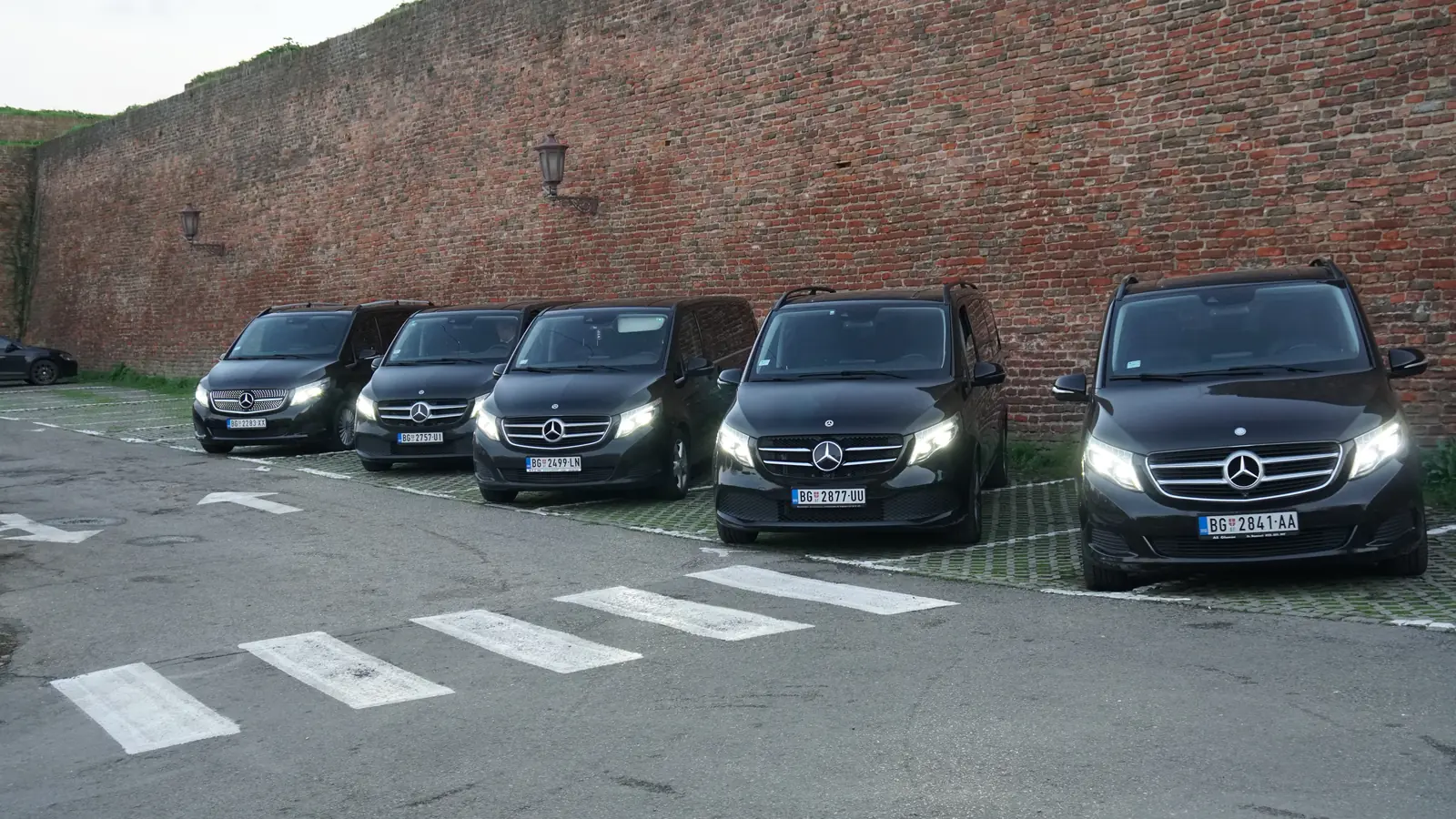 Five of our black Mercedes V-Class vans lined up