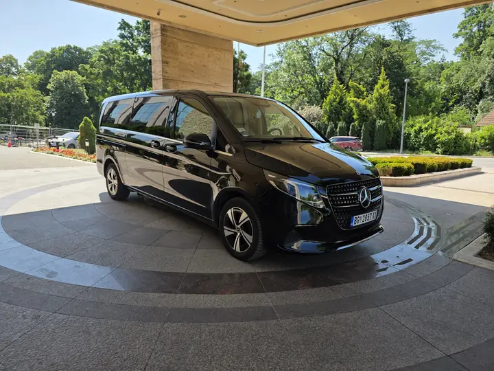 Our black Mercedes V-Class waiting at a hotel entrance