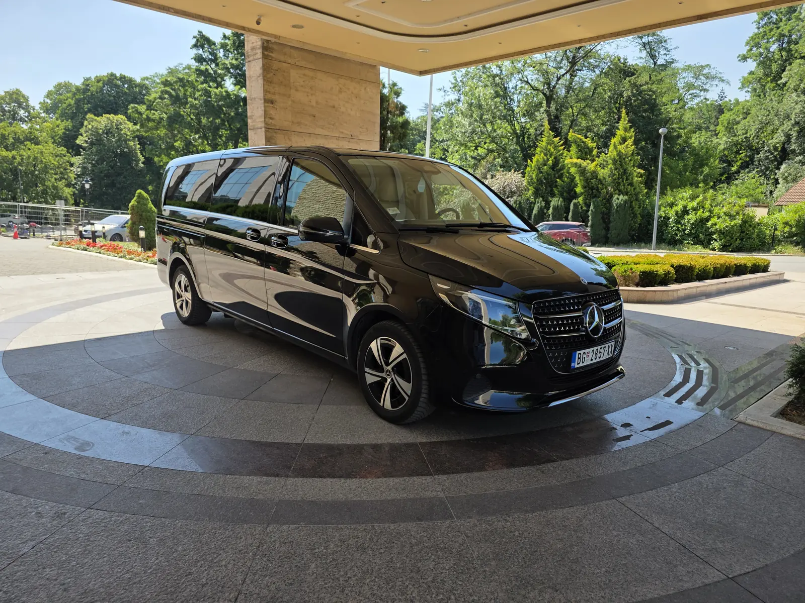 Our black Mercedes V-Class waiting at a Belgrade hotel entrance